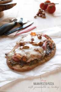 Easy pizza made of naan bread and topped with pesto, prosciutto and almonds | in my Red Kitchen